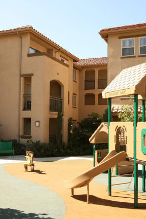 a playground in front of an apartment building