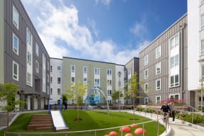 a rendering of a courtyard with a playground and buildings