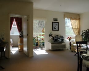 the living room and dining room of a house with a large window