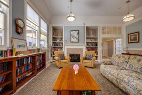 a living room with a fireplace and a coffee table