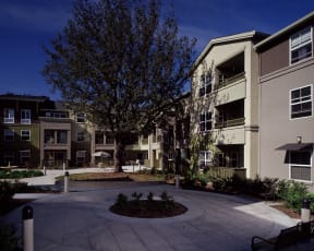 an empty courtyard in front of an apartment building