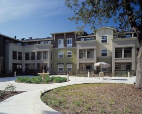 a group of apartment buildings with a courtyard in front of them