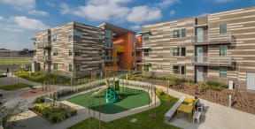 a playground is in the middle of a group of apartment buildings