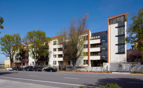 a rendering of a building with cars parked in front of it