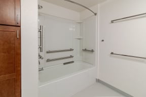 a bathroom with a shower and a wooden door
