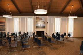 a large room with tables and chairs and a fireplace