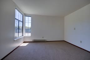 an empty room with carpet and a window