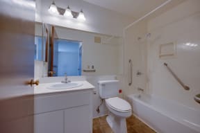 a bathroom with a sink toilet and a bath tub