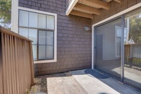 a sliding glass door opens to a patio outside of a home