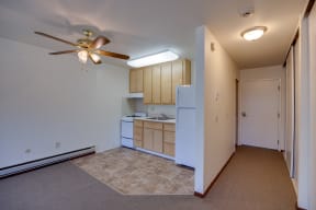 a view of a kitchen and a living room with a ceiling fan