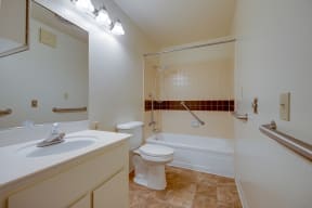 a bathroom with a toilet and a tub and a sink