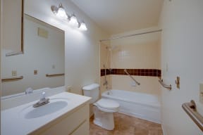 a bathroom with a sink toilet and a bath tub
