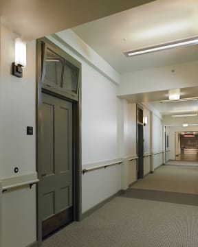 a hallway in a building with a door in the middle