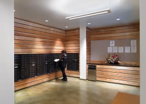 a person standing in a room with a bunch of lockers