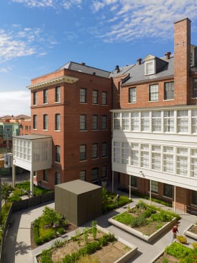 an aerial view of the courtyard of a building with a garden