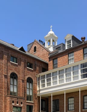 a church with a cross on top of a brick building
