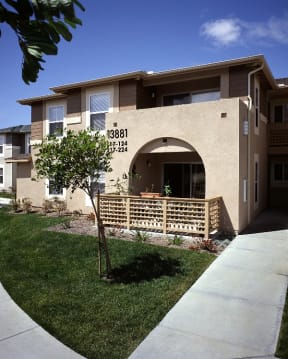 a house with a porch and a sidewalk in front of it