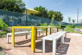 a picnic table and benches in a park
