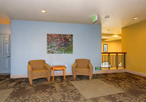 a living room with two chairs and a blue wall