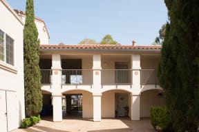a building with two balconies and a courtyard