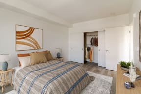 a bedroom with a bed and a closet