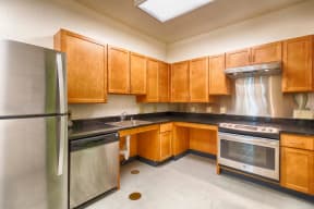 a kitchen with wooden cabinets and stainless steel appliances
