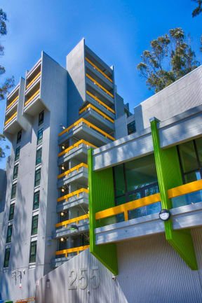 a view of a building with green and yellow balconies