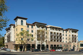 a large building with cars parked in front of it
