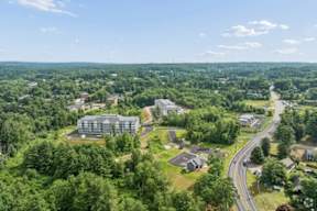 A bird's eye view of a residential area with a large building in the center.