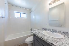 Bathroom with a toilet, sink and tub.