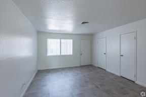 Room with a window and three doors.