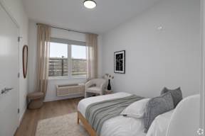 A Bedroom With Grey Pillows at Hue Soul Apartments, East Orange, NJ