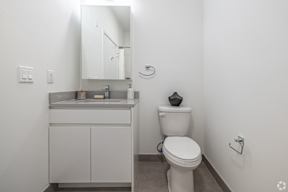 A Small Bathroom With White Toilet Sit at Hue Soul Apartments, East Orange, NJ