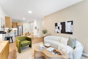 A Living Room With a White Couch at Hue Soul Apartments, East Orange