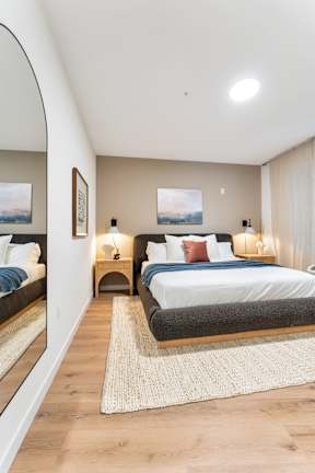 A Bedroom With Two Night Lamps at Hue Soul Apartments, New Jersey