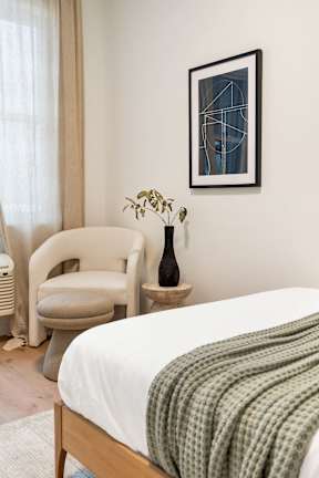 A Bedroom With a Chair at Hue Soul Apartments, New Jersey
