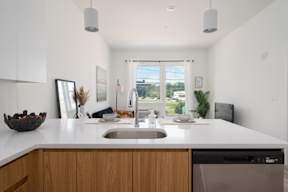 A modern kitchen with a wooden counter and a dishwasher.at Art Of Newark, Newark