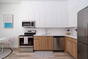 A kitchen with a refrigerator, oven, and microwave.at Art Of Newark, New Jersey, 07103
