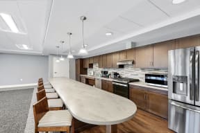 a kitchen with stainless steel appliances and a marble counter top