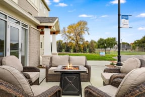the patio of a home with furniture and a fire pit