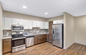 a kitchen with stainless steel appliances and white cabinets