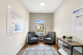a therapy room with two chairs and a table and a window