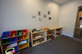 A room with toys and shelves.