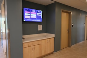 A wall with a TV displaying a menu.
