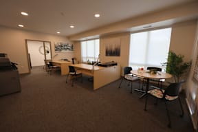 A conference room with a long table and chairs.