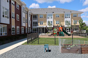 Apartment complex with a playground and a slide.