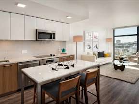 A modern kitchen with a dining table and chairs.