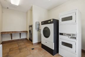 a kitchen with a washer and dryer and a laundry room with a sink