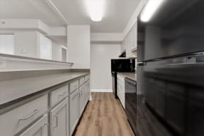 a kitchen with white cabinets and black appliances at Autumn Woods, Bladensburg, MD, 20710