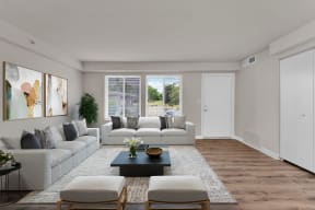 a living room with white walls and a wooden floor at Autumn Woods, Bladensburg